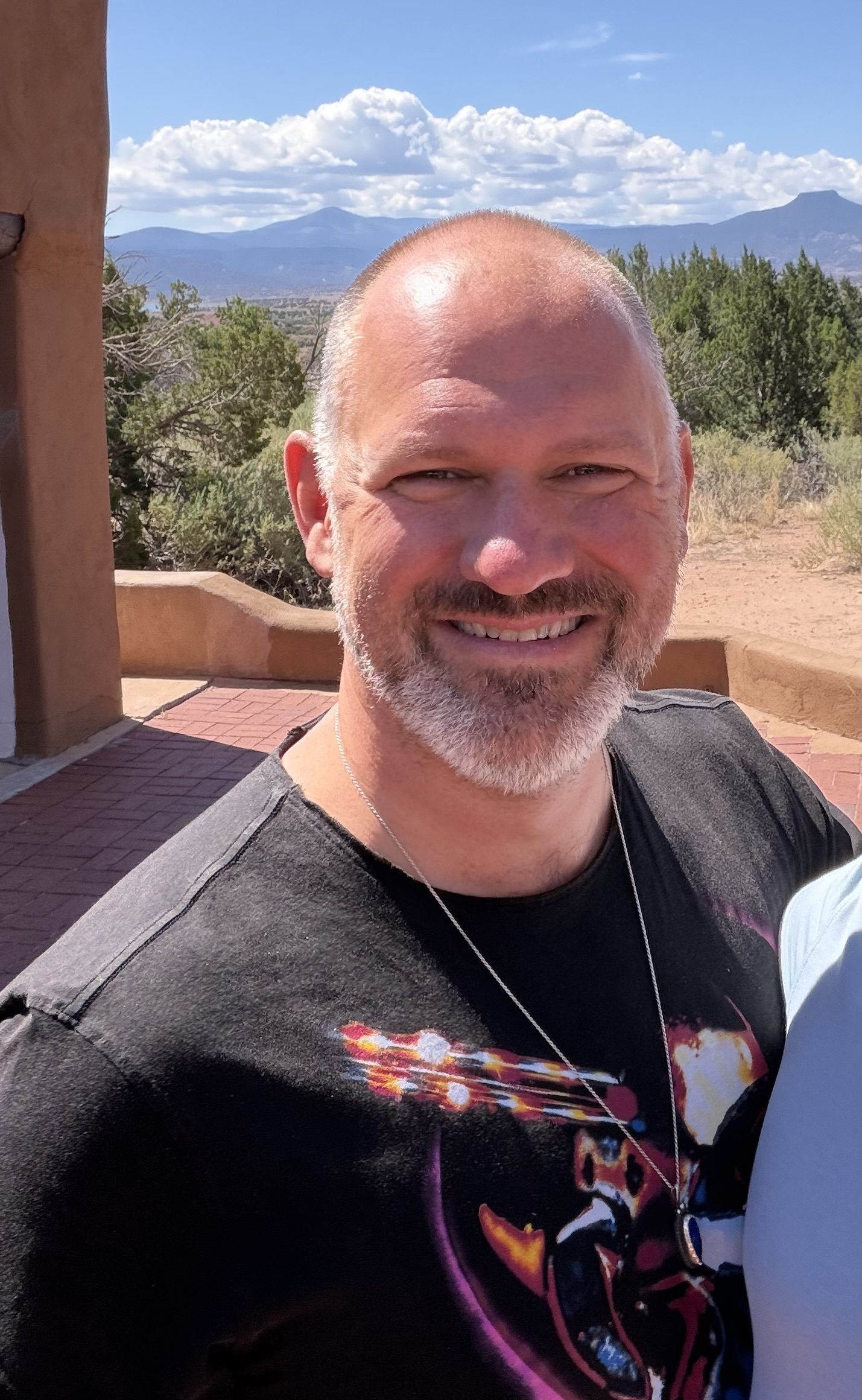 A photo of the artist with the New Mexico desert in the background